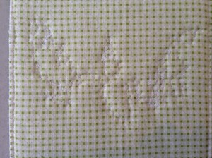 the thread sketching was done before the wadding and backing applied, then the image was stitched around to quilt it. Reducing the thread on the back.