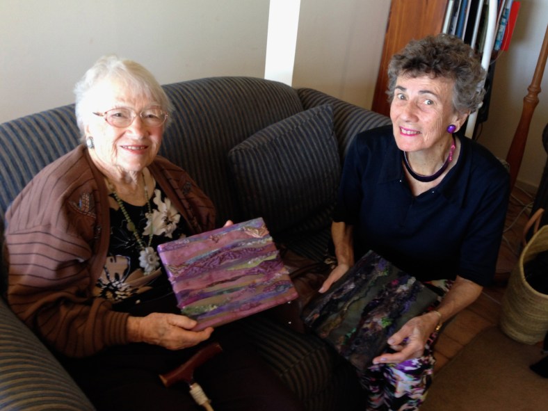Joyce Hyam and Cynthia Morgan having a look at Cynthia's bark texture pieces for the upcoming exhibition.