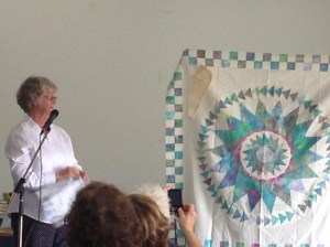 Lessa at a talk showing her Not a mariners compass 2 Sew Textiles